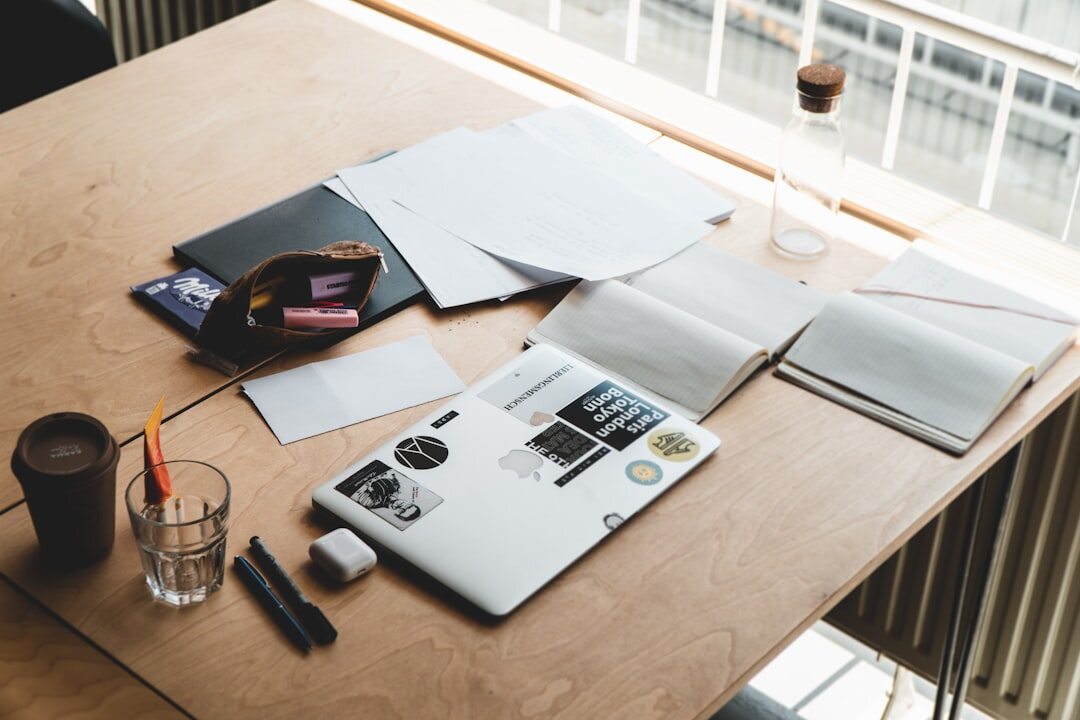 Journalist researching a story with documents and laptop on a desk