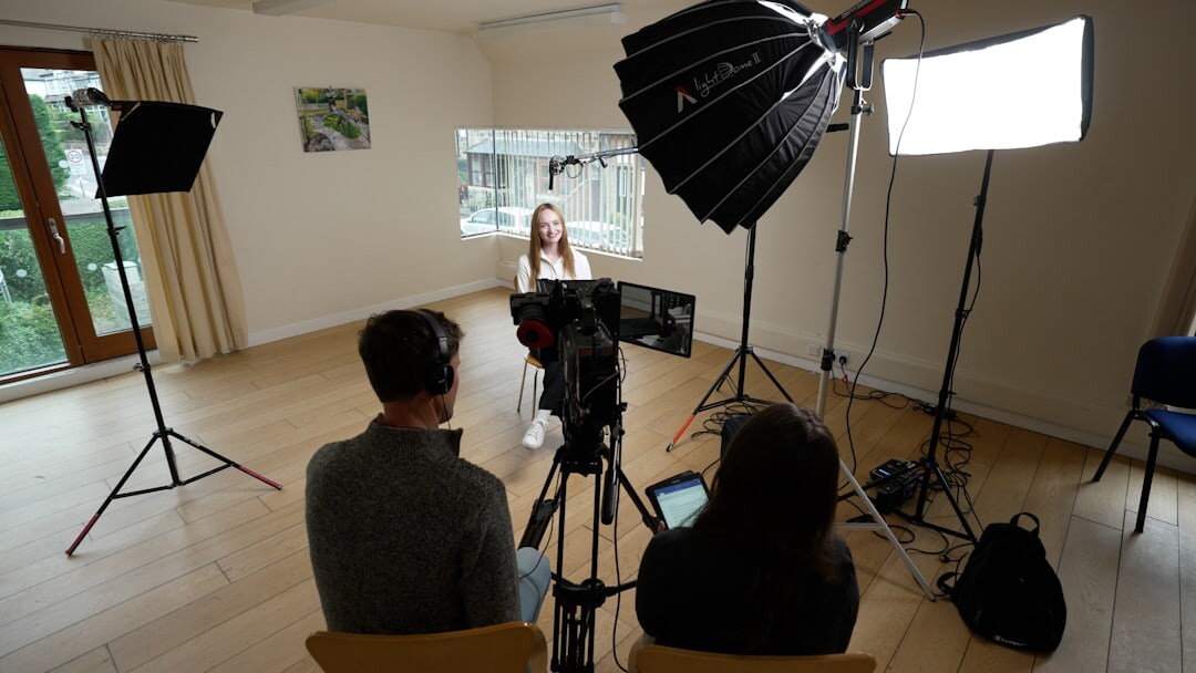 Video production team filming a news segment in a studio