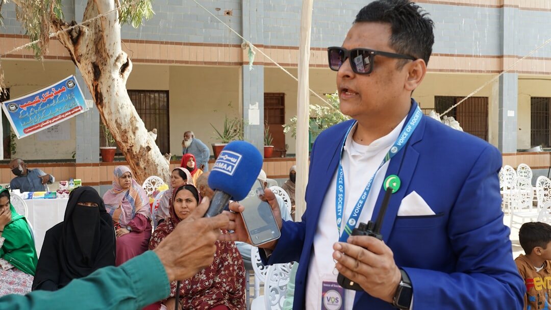Field journalist conducting an interview with a microphone outdoors