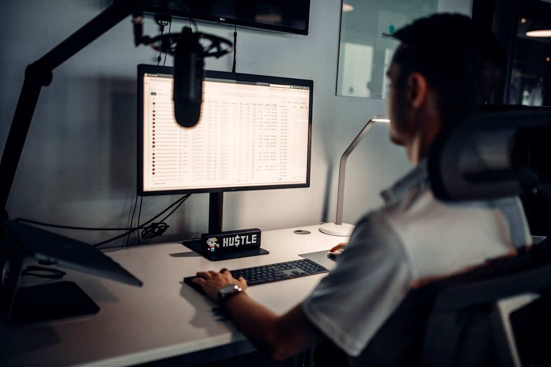 Journalist writing a broadcast script at a desk with scripts and a computer